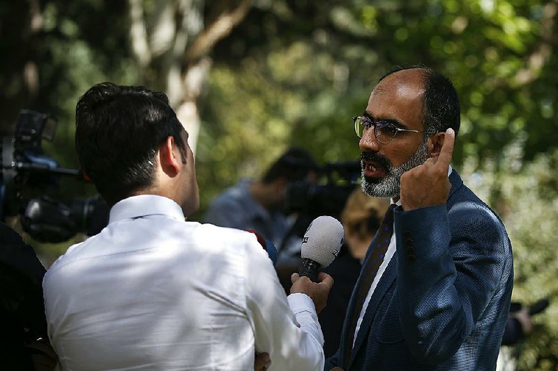 Turan Kislakci (right) head of the Turkish-Arab Media Association talks to members of the media regarding his missing friend Saudi writer Jamal Khashoggi, across from the Saudi Arabia consulate Sunday in Istanbul. 