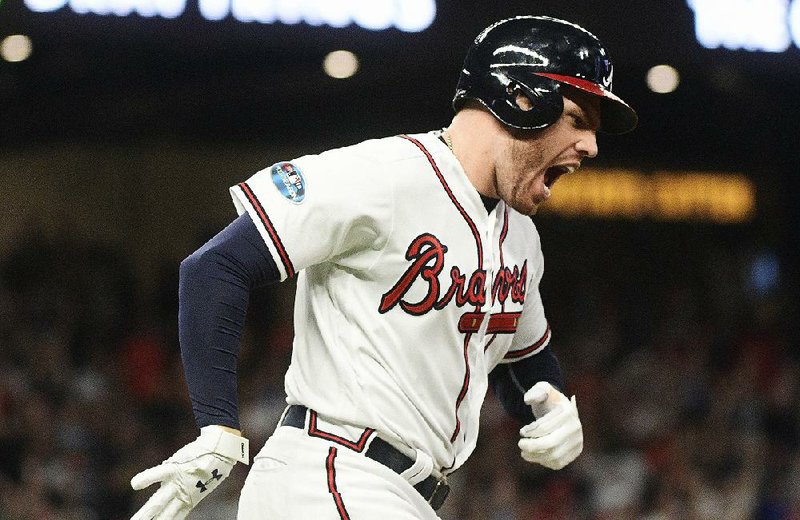 Atlanta Braves first baseman Freddie Freeman rounds the bases after hitting a tie-breaking home run in the sixth inning Sunday against the Los Angeles Dodgers in Game 3 of the National League division series Sunday in Atlanta. The Braves won 6-5 to force another game in the series at 3:30 p.m. today.