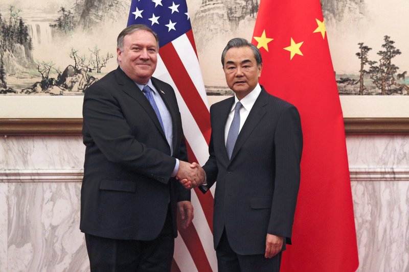 U.S. Secretary of State Mike Pompeo, left, shakes hands with Chinese Foreign Minister Wang Yi before their meeting at the Diaoyutai State Guesthouse in Beijing, Monday, Oct. 8, 2018. Pompeo said Monday that he and North Korean leader Kim Jong Un made "significant progress" toward an agreement for the North to give up its nuclear weapons. While significant work remains to be done, he said he expected further results after an as-yet unscheduled second summit between Kim and President Donald Trump. (AP Photo/Andy Wong, Pool)

