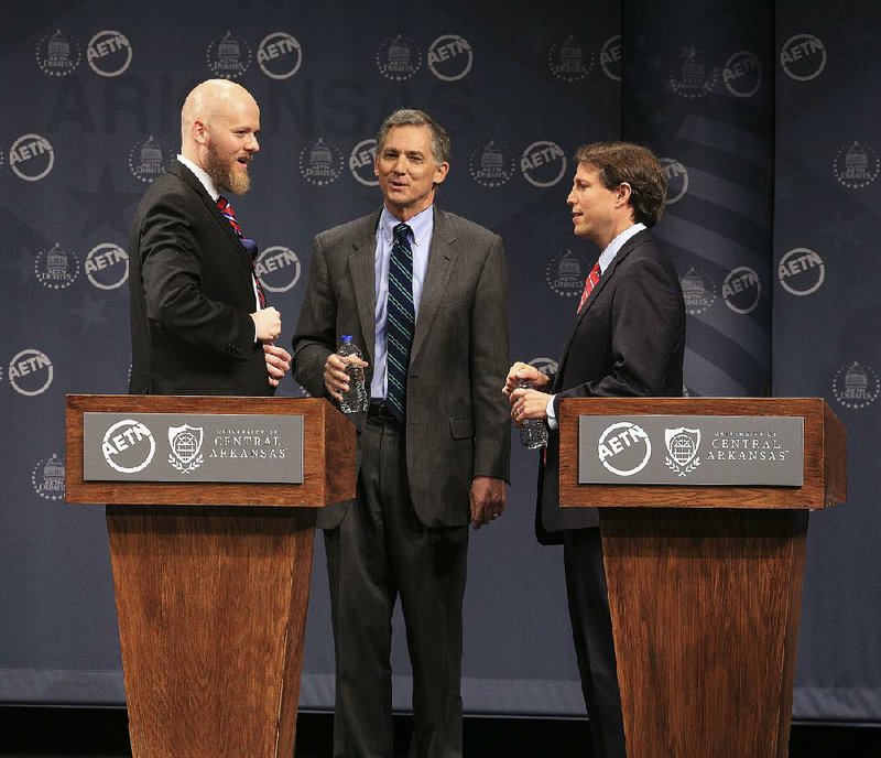 Libertarian Joe Ryne Swafford (from left), Republican U.S. Rep. French Hill and Democratic state Rep. Clarke Tucker talk Monday after their 2nd Congressional District debate in Conway.