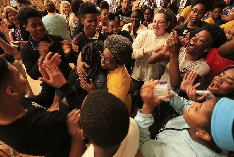 Little Rock Central High School students congratulate teacher Stacey McAdoo (center) after she was named Arkansas’ 2019 Teacher of the Year during a ceremony Monday at the school.