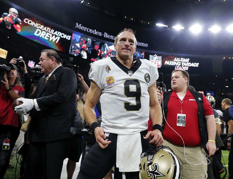 New Orleans Saints quarterback Drew Brees (9) reacts after breaking the NFL all-time passing yards record in the first half of an NFL football game against the Washington Redskins in New Orleans, Monday, Oct. 8, 2018.