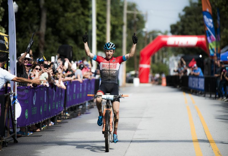 NWA Democrat-Gazette/CHARLIE KAIJO Keegan Swenson of Heber City, Utah reacts as he crosses the finish line to place first in the men's race of the Epic Rides Oz Trails Off-Road championship mountain bike race, Sunday, October 7, 2018 at the downtown square in Bentonville.