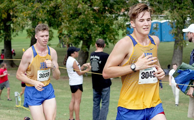 Photo submitted JBU cross country runners Ryan Knight and Clay Popkess run during the Oklahoma Baptist Invitational on Saturday in Shawnee, Okla.