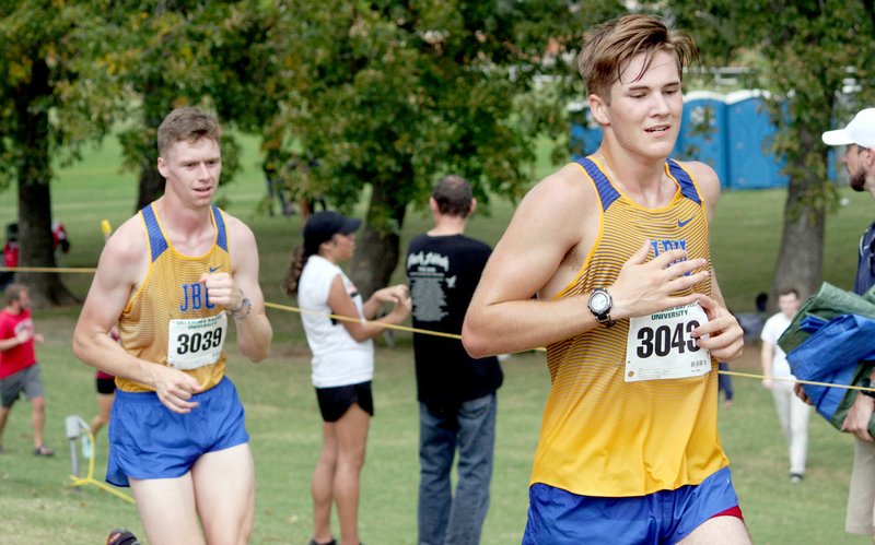 Photo submitted JBU cross country runners Ryan Knight and Clay Popkess run during the Oklahoma Baptist Invitational on Saturday in Shawnee, Okla.