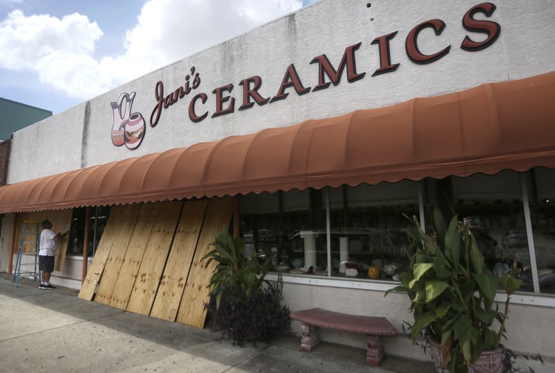 Bobby Smith boards up the windows at Jani's Ceramics in Panama City, Fla., on Monday, Oct. 8, 2018, in preparation for the arrival of Hurricane Michael. (Patti Blake/News Herald via AP)

