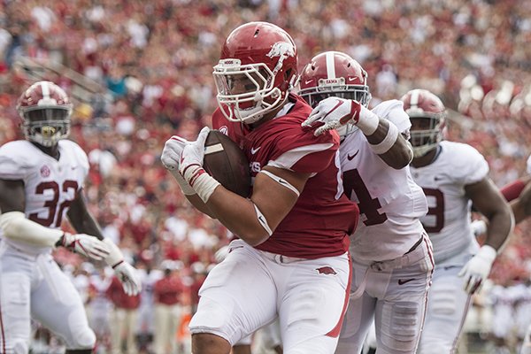 Arkansas tight end Cheyenne O'Grady reels in a touchdown pass under pressure from Alabama safety Deionte Thompson in the second quarter of a game Saturday, Oct. 6, 2018, at Razorback Stadium in Fayetteville.
