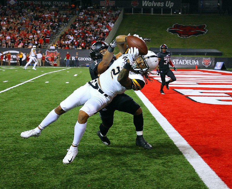 Appalachian State wide receiver Corey Sutton (2) makes a catch for a touchdown in front of Arkansas State defensive back B.J. Edmonds during the Mountaineers’ victory over the Red Wolves on Tuesday night at Centennial Bank Stadium in Jonesboro.