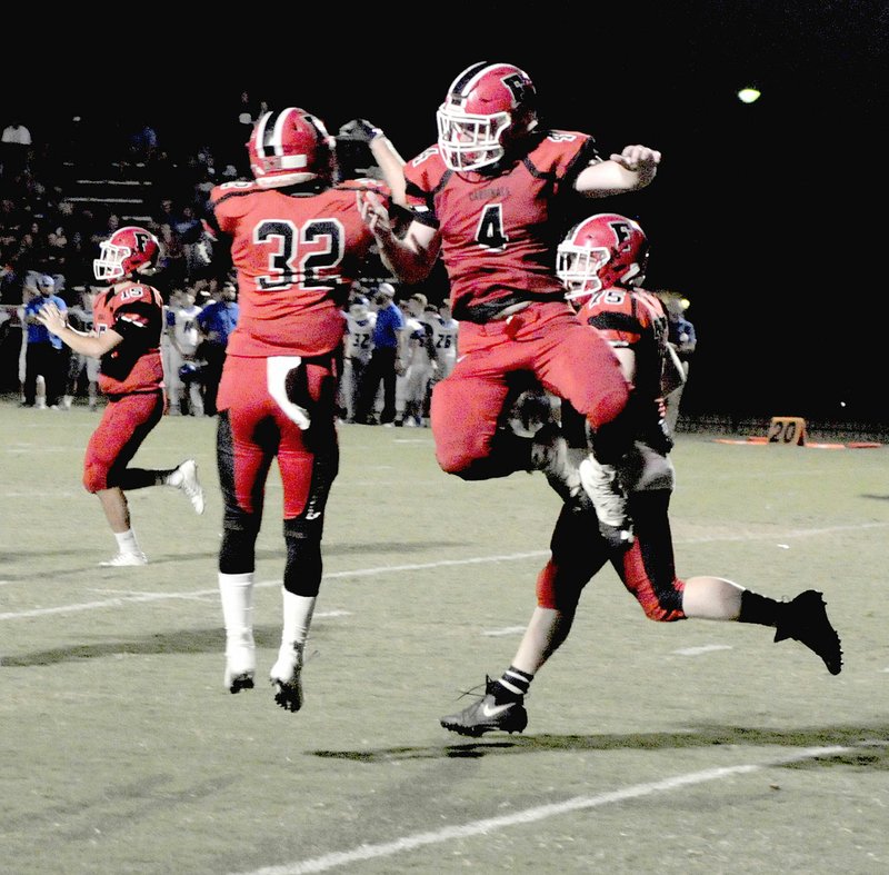 MARK HUMPHREY ENTERPRISE-LEADER Farmington seniors: tailback Reid Turner (left) and fullback Rhett Rominger celebrate Rominger's 1-yard touchdown plunge. The Cardinals were defeated, 28-14, in their Homecoming game by Greenbrier on Friday, Oct. 5, 2018.