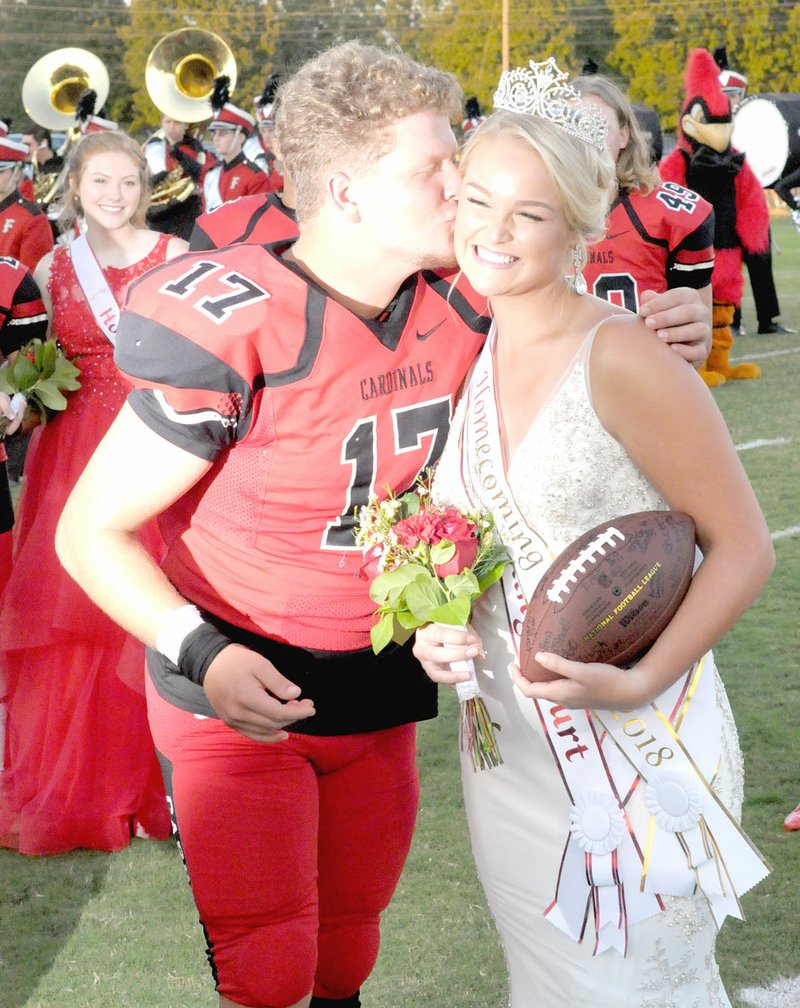 MARK HUMPHREY ENTERPRISE-LEADER Farmington senior Mary Stewart-Beard receives a congratulatory kiss from classmate Jacob Freeman after being crowned Homecoming queen during Friday's festivities at Allen Holland Field.