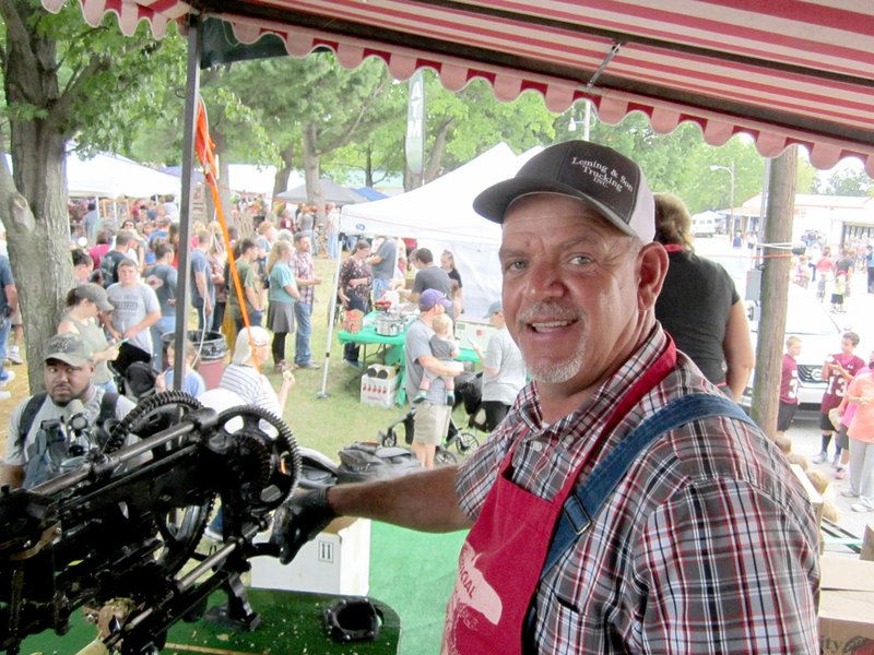 DENISE NEMEC SPECIAL TO ENTERPRISE-LEADER Lincoln Fire Chief Willie Leming was one of many volunteers at the Apple Festival over the three-day weekend. Leming volunteered to slice fresh apples to hand out to visitors.