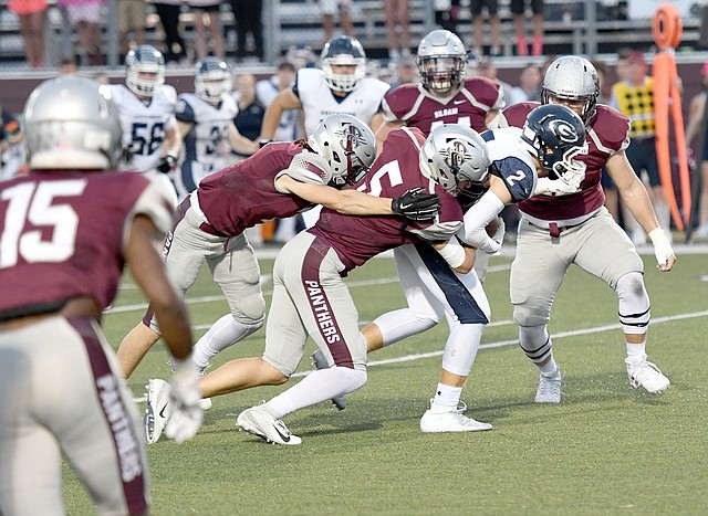 Bud Sullins/Special to the Herald-Leader A host of Siloam Springs defenders wrap up Greenwood's Luke Leonard during last Friday's homecoming game at Panther Stadium. Siloam Springs travels to Lake Hamilton this Friday for a 6A-West Conference game.
