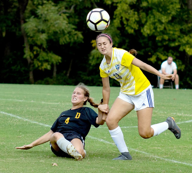 Photo courtesy of JBU Sports Information John Brown sophomore defender Audrey Balafas, right, battles Science and Arts (Okla.) defender Grace Schmidt for the ball during Saturday's match at Alumni Field. The Drovers defeated the Golden Eagles 2-1.