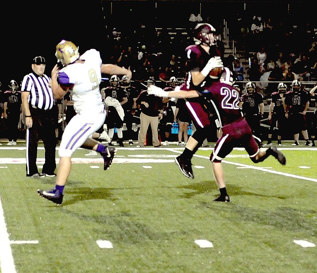 MARK HUMPHREY ENTERPRISE-LEADER Lincoln senior Sterling Morphis makes a leaping interception of a pass intended for Berryville's Ethan Gregory (No. 9) while Morphis' teammate Blake Arnold (No. 22) tries to avoid dislodging the ball. Morphis hung on and returned the pick 42 yards to set up a Wolf touchdown during Lincoln's 41-7 Homecoming victory over the Bobcats on Friday, Oct. 5, 2018.