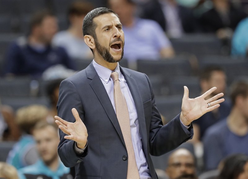 In this Oct. 2, 2018, file photo, Charlotte Hornets head coach James Borrego directs his team against the Miami Heat during the first half of a preseason NBA basketball game, in Charlotte, N.C. Borrego is the first Hispanic-American head coach in the NBA. 