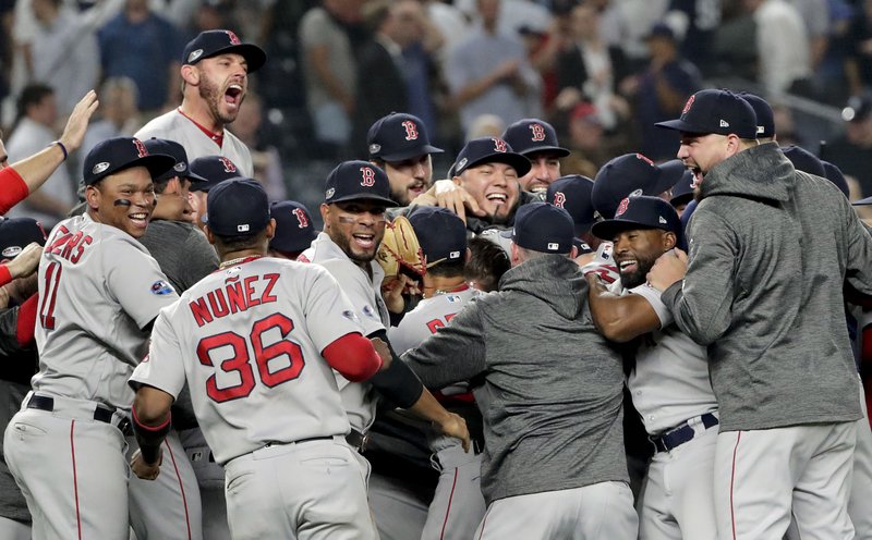 The Boston Red Sox celebrate after beating the New York Yankees 4-3 in Game 4 of baseball's American League Division Series, Tuesday, Oct. 9, 2018, in New York. 