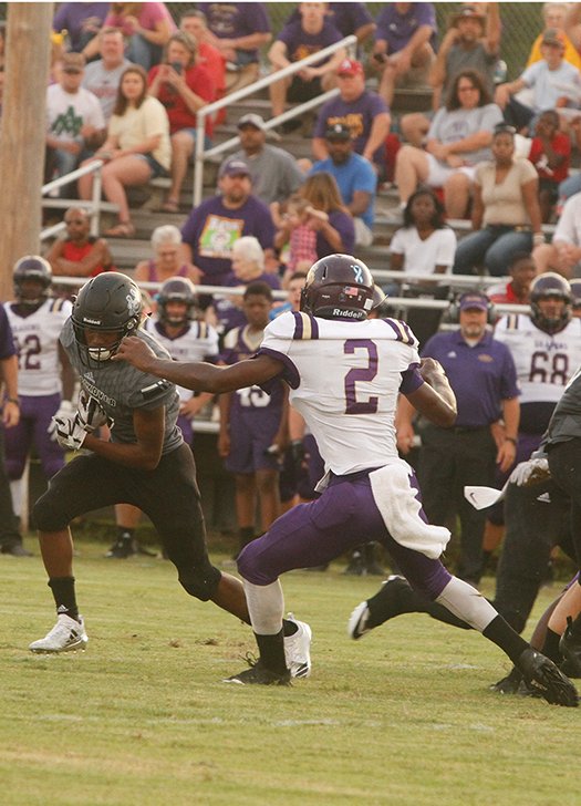 Terrance Armstard/News-Times Smackover running back Dexter Crockett tries to run past Junction City's Jamie Carroll during their contest at Smackover earlier this season. On Friday, Smackover hosts Fouke in 5-3A play, while the Dragons host Bearden after having a bye week. Both schools are hosting homecoming this week.