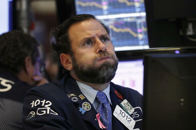 Specialist Michael Pistillo watches stocks plummet Wednesday on the floor of the New York Stock Exchange. 