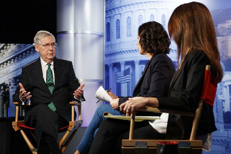 Senate Majority Leader Mitch McConnell speaks Wednesday with Associated Press journalists Julie Pace (center) and Lisa Mascaro. He said Democrats will pay a political price if they win in midterm elections and use their majority to dig into investigating the president.