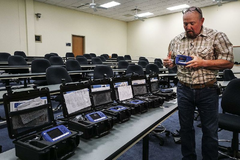 Russell Johnson, a contract instructor for Thermo Scientific, demonstrates the new TruNarc Handheld Narcotics Analyzer that the Arkansas State Police received Wednesday at state police headquarters in Little Rock. 