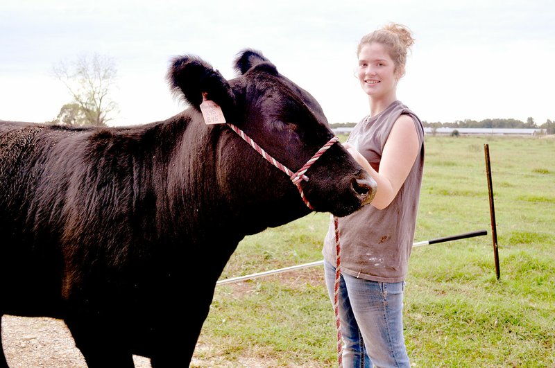 RACHEL DICKERSON/MCDONALD COUNTY PRESS Brandie Keith, 4-H member, is pictured with her Simmental heifer, Stella, which she recently showed in Tulsa.