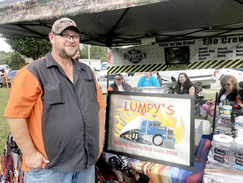 Sally Carroll/McDonald County Press Scott House, &quot;Lumpy,&quot; takes time away from stirring his chili at the chili cookoff on Saturday in Noel. House, of Garfield, Ark., has competed for at least three years in the annual chili cookoff hosted by the McDonald County Chamber of Commerce. This year's event was hosted by the Noel Betterment Association with a change of venue in Noel.