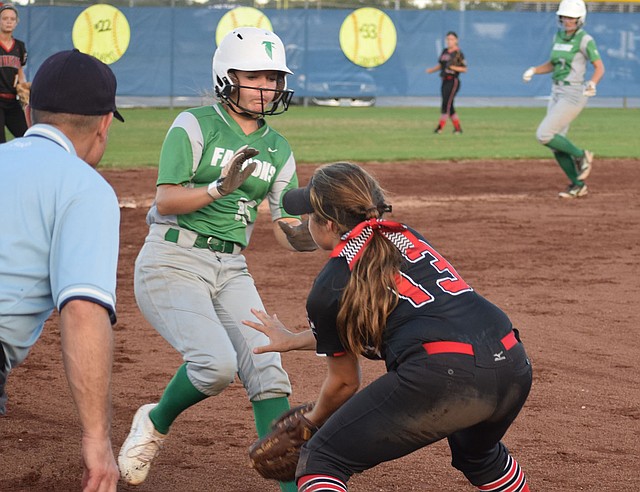 RICK PECK/SPECIAL TO MCDONALD COUNTY PRESS McDonald County third baseman Whitney Kinser tries to dodge Makenna Kliethermes of Blair Oaks to catch a throw during the Lady Mustangs' 10-3 loss at the 19th Annual Carthage Softball Invitational.