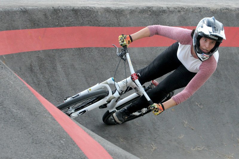 NWA Democrat-Gazette/DAVID GOTTSCHALK Romana Labounkova, of the Czech Republic, takes a practice run Tuesday, October 9, 2018, on the pump track at the Runway Bicycle Skills Park at the Jones Center in Springdale. The park will host the Pump Track (bicycling) World Championships sponsored by Red Bull on Saturday, October 13. A pump track is designed so that bikers pump and push on hills and turns to build speed using their upper body and hips instead of pedaling.