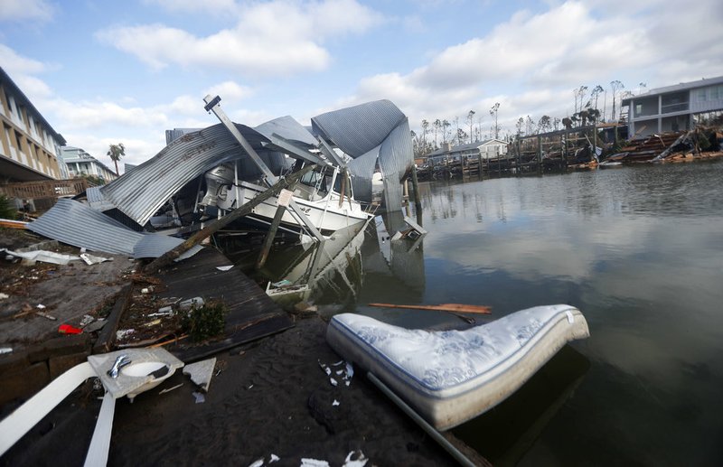 A boat sits amidst debris in the aftermath of Hurricane Michael in Mexico Beach, Fla., on Thursday, Oct. 11, 2018.