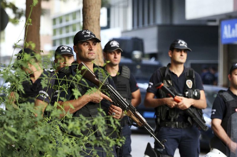 Police officers stand guard Thursday in Izmir, Turkey, near the residence of U.S. pastor Andrew Brunson a day before the start of his trial.