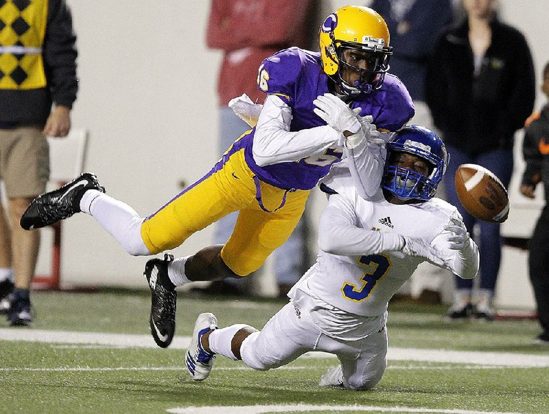 North Little Rock cornerback Sedrick Cain (3) breaks up a pass intended for Little Rock Catholic’s Robert Bavon during the second quarter of the Charging Wildcats’ 49-17 victory over the Rockets.