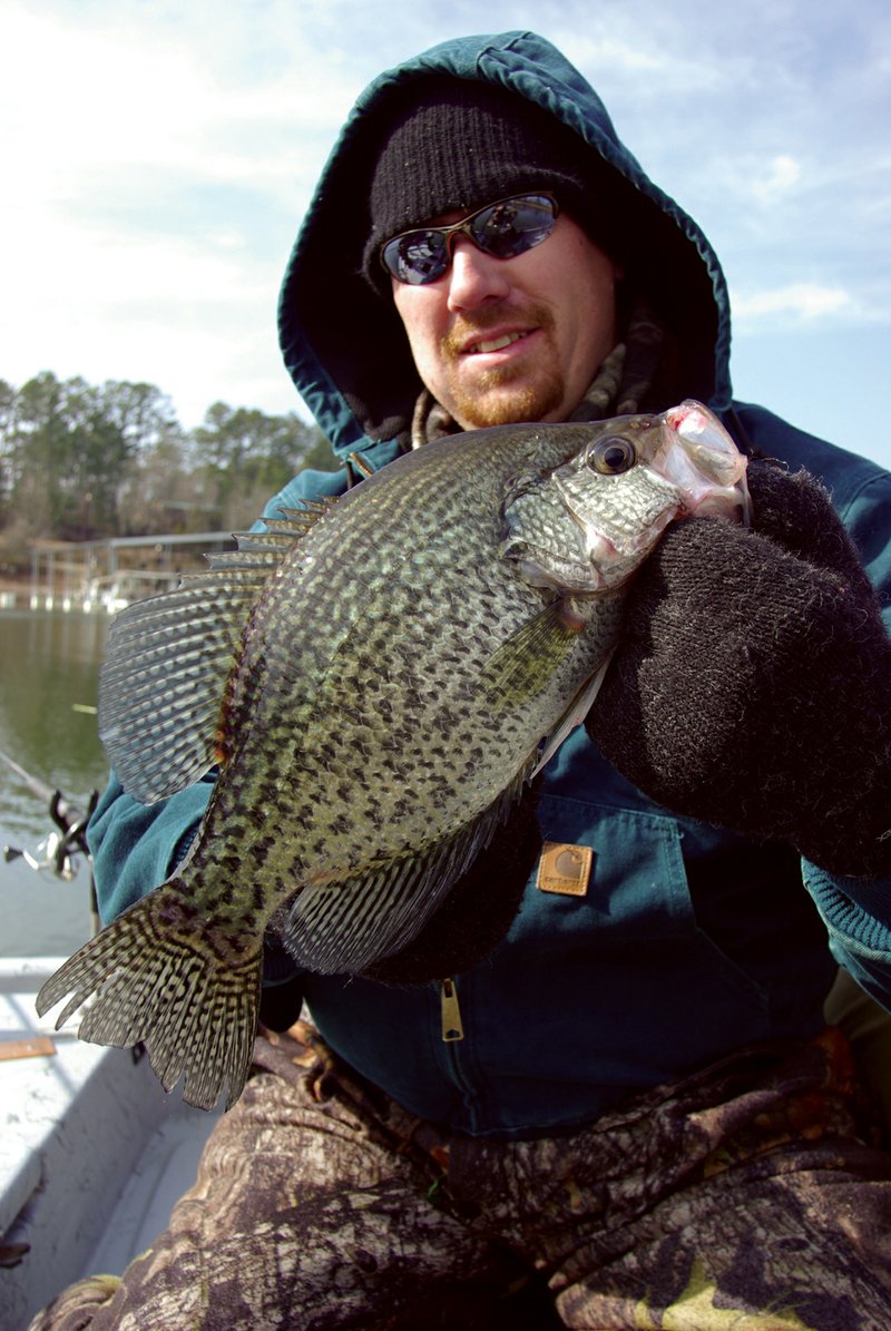 During cold weather, proper outerwear can mean the difference between having fun and being miserable when enjoying outdoor activities like fishing. Here, Josh Sutton of Wynne is bundled in outerwear for a winter crappie trip on Lake Greeson.