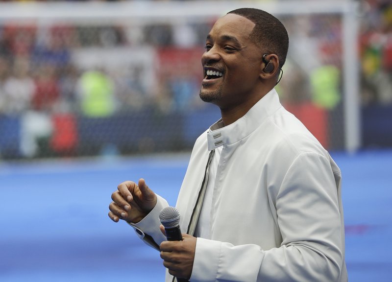 FILE - In this July 15, 2018, file photo, singer and actor Will Smith performs during the closing ceremony prior to the final match between France and Croatia at the 2018 soccer World Cup in the Luzhniki Stadium in Moscow, Russia. The star on Wednesday, Oct. 10, revealed the first poster of Disney's remake of &quot;Aladdin.&quot; Smith, who plays the Genie, wrote on Facebook: &quot;LEMME OUT! Can't wait for y'all to see Me BLUE.&quot; (AP Photo/Matthias Schrader, File)