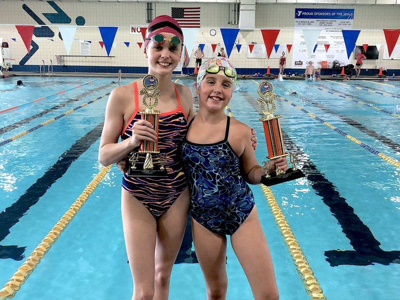 TOP SEALS: Hot Springs Family YMCA Seals swim team members Emma Crowe, left, and Audrey Simons won the high point awards for their divisions on Saturday at the 55th annual Aquakids Bob Courtway Swim Meet in Conway.