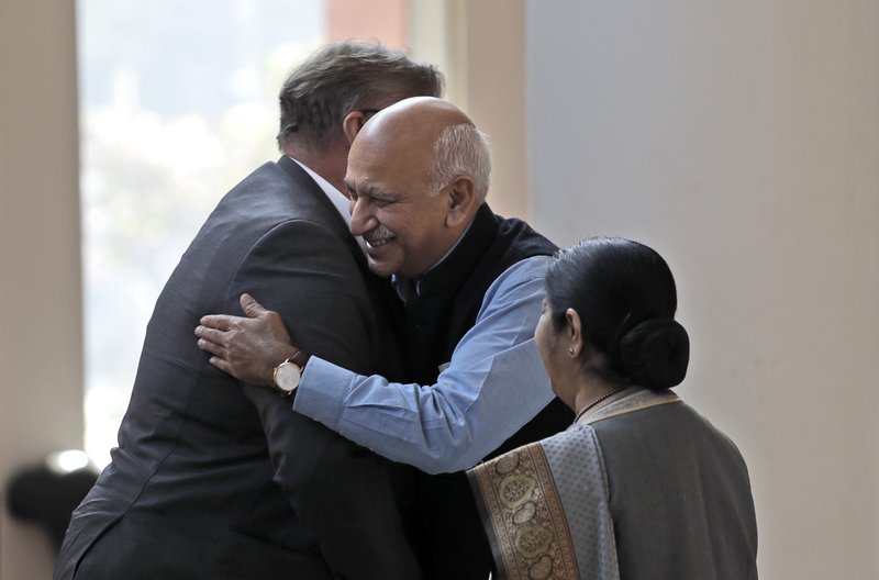 In this Nov. 24, 2017 file photo, Indian Junior Foreign Minister M.J. Akbar, center, hugs Finland's Foreign Minister Timo Soini in New Delhi, India. 
