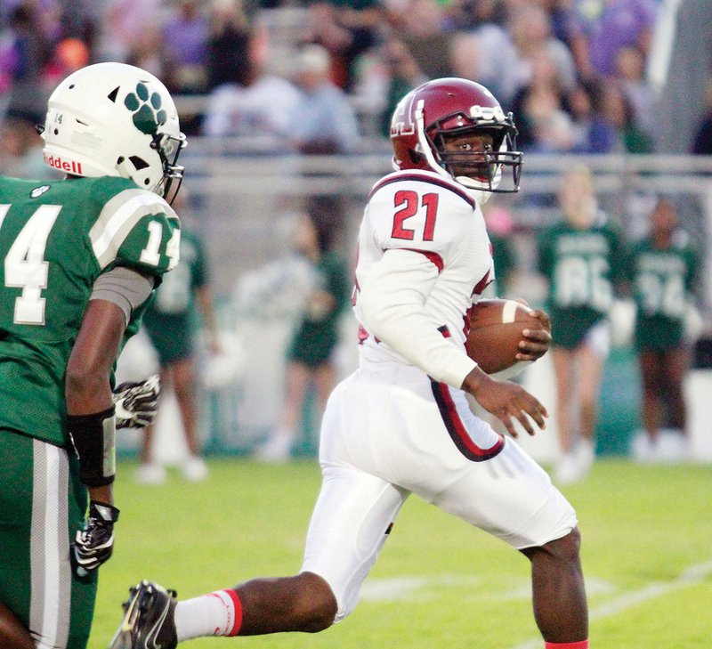 Augusta running back Zack McLucas, No. 21, speeds away from Episcopal’s Hayden Smith en route to a first-quarter touchdown in the Red Devils’ 34-32 win over the Wildcats in Little Rock on Sept. 28.