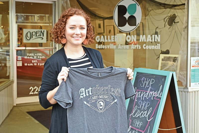 Carly Dahl, executive director for the Batesville Area Arts Council, holds a T-shirt for Artoberfest, the annual arts festival, which will take place Saturday on Main Street in Batesville.