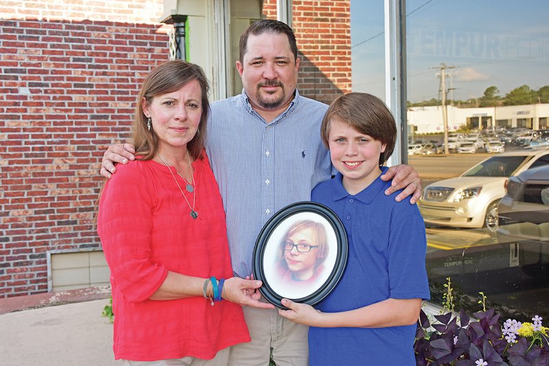 Jennifer and Jeremy James and their son, Jonas, 12, hold a photo of Jesse Dylan James. The couple’s 14-year-old son died by suicide in September 2017, and the couple formed the Jesse Dylan James Foundation. The second Jammin’ for Jesse event is scheduled for 4:30-10 p.m. Saturday at the White County Fairgrounds in Searcy. Bands will perform, and there will be food and activities, including a dunking booth, bounce houses and face-painting. The event is free, but donations will be accepted.