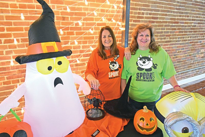 Wanda Posey, left, and Joyce Robinson, co-directors of the 12th annual Spook City in downtown Benton, pose behind some Halloween decorations. Spook City, scheduled for 5 p.m. Saturday, is a free event that features tons of candy, rides and inflatables.