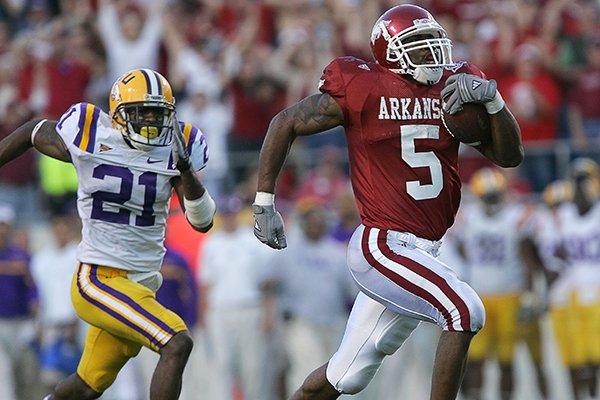 Arkansas running back Darren McFadden outruns LSU defensive back Chevis Jackson for an 80-yard touchdown during the fourth quarter of a game Friday, Nov. 24, 2006, in Little Rock. McFadden broke Madre Hill's single-season school rushing record on the play. 