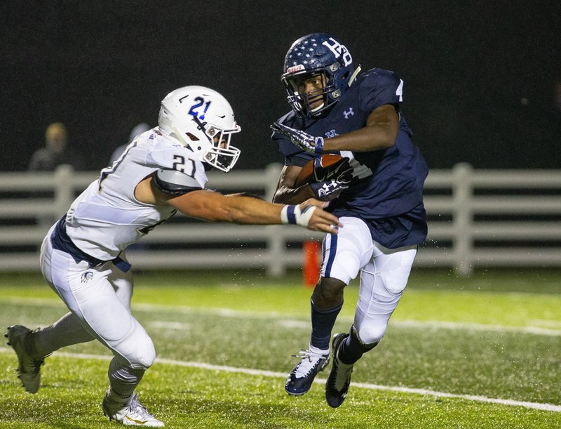 Bentonville West vs Springdale Har-ber - Jay Burns of Sprindale Har-ber runs the ball as Jonas Higson (21) of Bentonville West tries to bring him down at Wildcat Stadium, Springdale, AR on Friday, October12, 2018. Special to NWA Democrat-Gazette/ David Beach