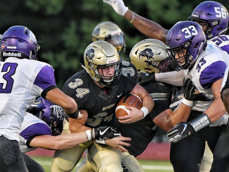 Submitted photo BISONS RUN: Harding running back Cole Chancey (34) fights for yards against the Ouachita Baptist defense a week ago during the Bisons' 7-3 loss to the Tigers in Searcy. Photo by Jeff Montgomery, courtesy of Harding University Athletics.