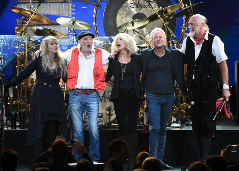 FILE - In this Jan. 26, 2018 file photo, Fleetwood Mac band members, from left, Stevie Nicks, John McVie, Christine McVie, Lindsey Buckingham and Mick Fleetwood appear at the 2018 MusiCares Person of the Year tribute honoring Fleetwood Mac in New York. Buckingham is suing his bandmates in Fleetwood Mac for kicking him off the band&#x2019;s new tour. In the suit, the Hollywood Reporter says the guitarist and songwriter is seeking his share of the tour because he says he still wants and is able to perform. The more than 50-city tour starts Friday, Oct. 12 in Nebraska, with Mike Campbell and Neil Finn replacing Buckingham. (Photo by Evan Agostini/Invision/AP, File)