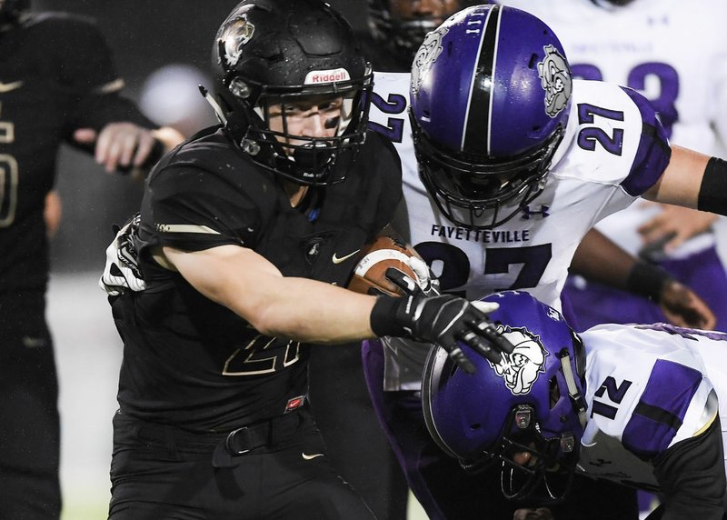 NWA Democrat-Gazette/CHARLIE KAIJO Bentonville High School Harrison Campbell (21) carries the ball during a football game, Friday, October 12, 2018 at Tiger Stadium in Bentonville High School in Bentonville.