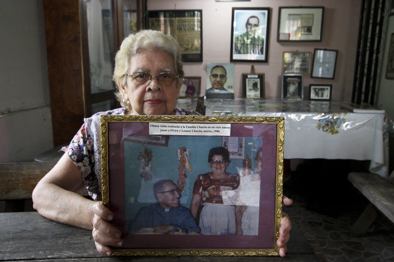 In this Oct. 4. 2018 photo, Leonor Chacon shows a March 1980 photograph of Archbishop Oscar Arnulfo Romero a few days before the was assassinated, at her house in Santa Tecla, El Salvador. Leonor maintains a special space in one of the rooms of her house with Romero memorabilia. (AP Photo/Salvador Melendez)