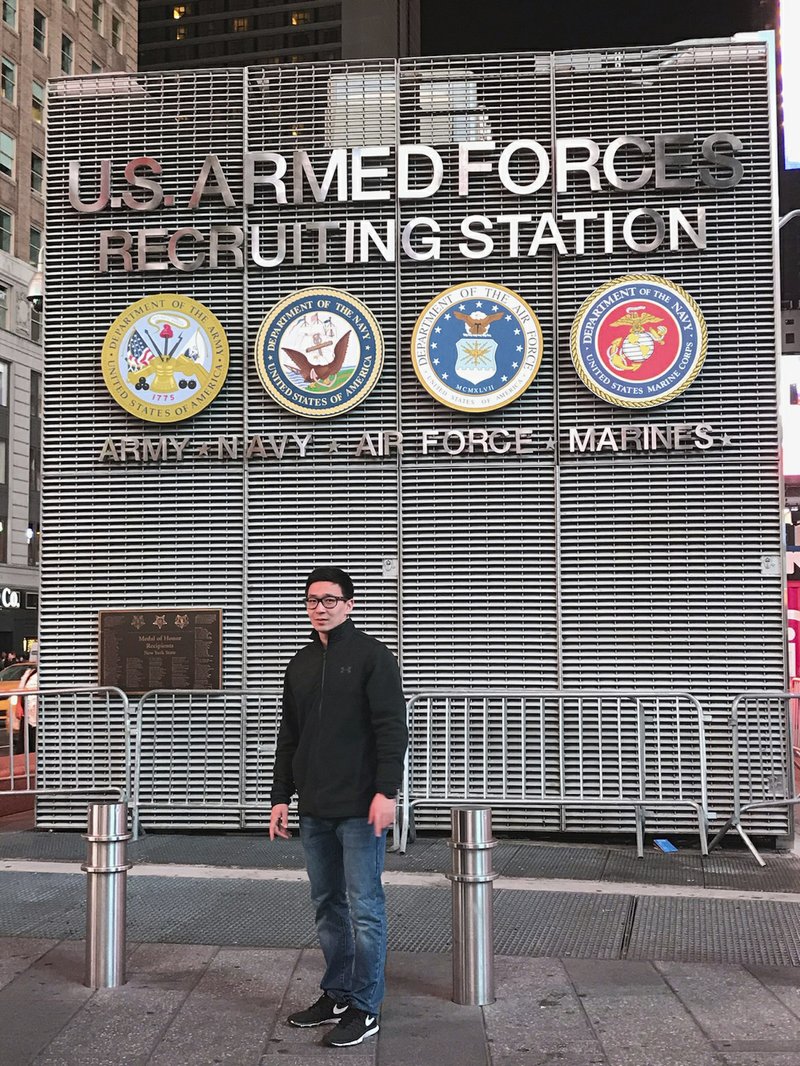 This November 2017 photo provided by Badamsereejid Gansukh shows him in front of a U.S. military recruiting office in New York's Times Square. Gansukh, whose recruiter told him his Turkish language skills would be an asset to the military, said he didn&#x2019;t know he was discharged at all until he asked his congressman&#x2019;s office in the summer of 2018 to help him figure out why his security screening was taking so long. (Courtesy of Badamsereejid Gansukh via AP)