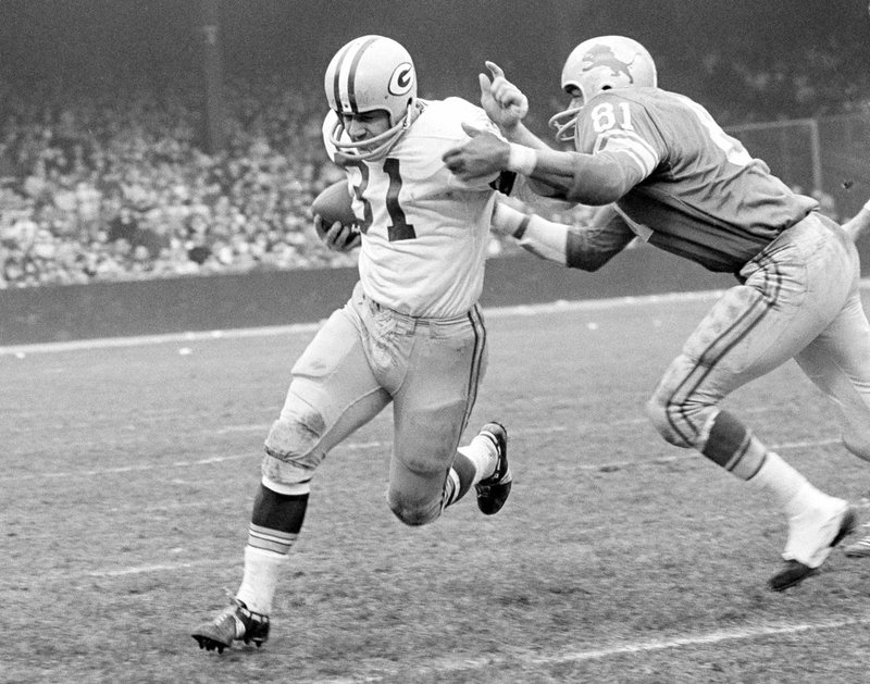 FILE - In this Nov. 22, 1962, file photo, Green Bay Packers fullback Jim Taylor (31) is brought down by Detroit Lions' Dick Lane in the third quarter of an NFL football game in Detroit. The Hall of Fame fullback died early Saturday, Oct. 13, 2018, the Packers announced. He was 83. (AP Photo/Preston Stroup, File)