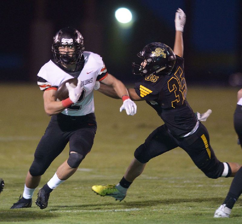 Pea Ridge running back Samuel Beard (left) rushed for 220 yards and one touchdown in Pea Ridge’s 38-29 victory over Prairie Grove on Friday night. 