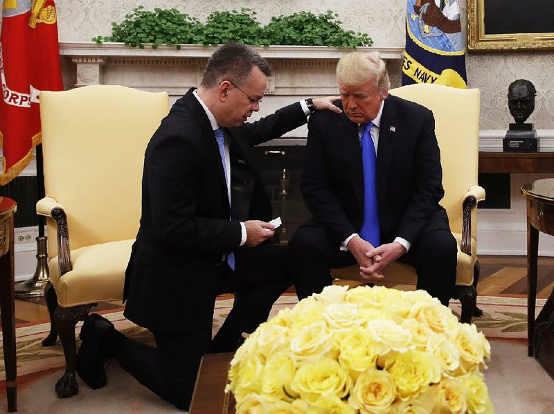 Pastor Andrew Brunson prays with President Donald Trump in the Oval Office on Saturday, asking that God grant Trump “supernatural wisdom.” 