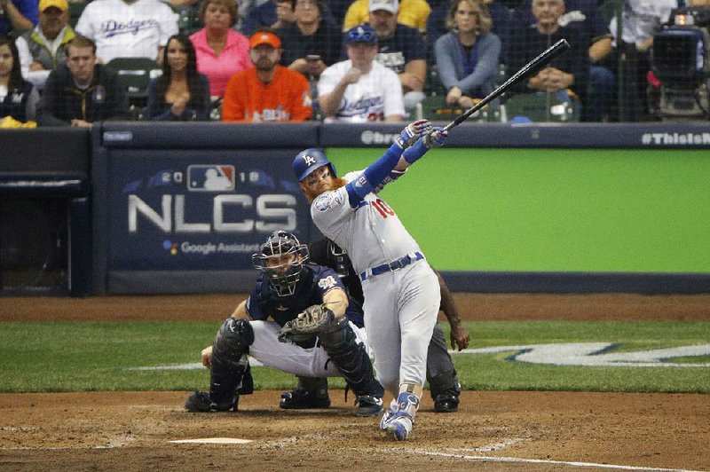 Justin Turner hits a two-run home run during the eighth inning of Game 2 of the National League Championship Series to put the Los Angeles Dodgers ahead in a 4-3 victory against the Milwaukee Brewers on Saturday in Milwaukee. The series is tied 1-1.   